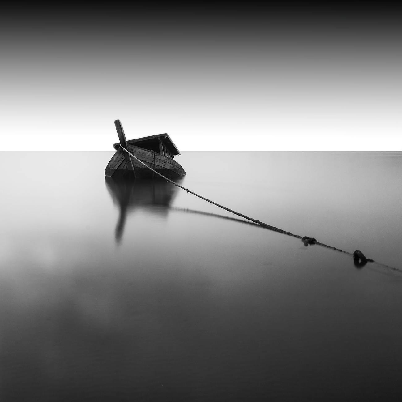 grayscale photography of boat on calm water
