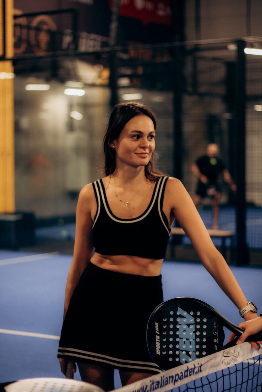young woman playing padel tennis indoors