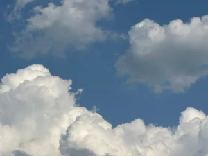 fluffy white clouds against clear blue sky
