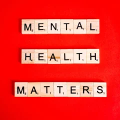 mental health matters spelled on letter tiles on red background