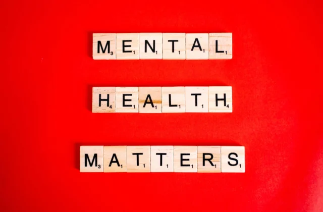 mental health matters spelled on letter tiles on red background