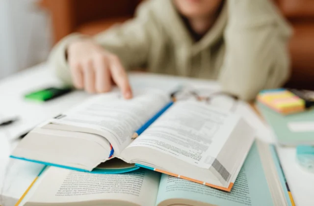 person touching a book