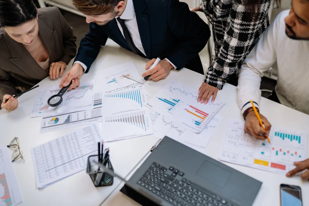 people working together by table at office